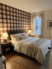 Burgundy and caramel tartan wallpaper in a bedroom.