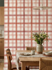 Red watercolour plaid wallpaper in a dining area.
