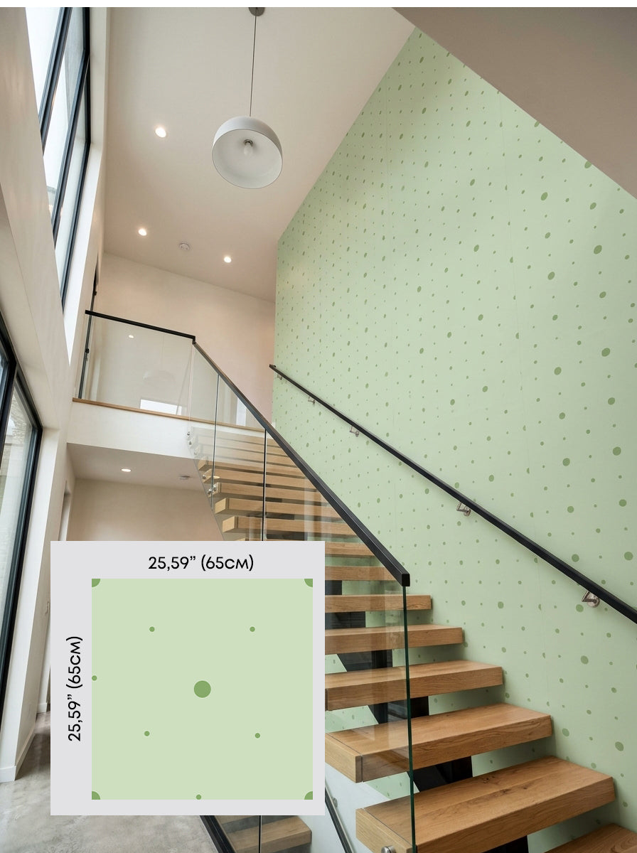 Sage polka dot wallpaper on a staircase wall, shown with a 65 cm (25.6 in) pattern sample.