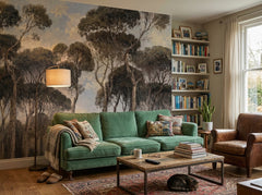 Moody pine forest wallpaper behind a green sofa in a cozy living room.