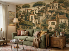 Mediterranean village wallpaper behind a green sofa in a cozy living room.