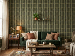 Sage green retro capsule wallpaper behind a green velvet sofa in a living room.