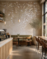 Blossoming branches on beige wallpaper in a specialty coffee shop.