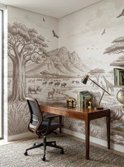 Sepia savanna wallpaper in a home office with a walnut desk and a task chair.