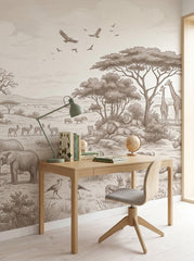 Sepia safari elephants wallpaper above a light wood desk with a green lamp.