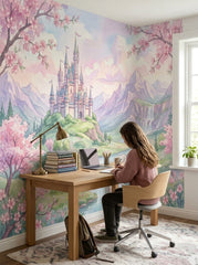Pink fairytale castle wallpaper behind a wooden desk in a study corner.