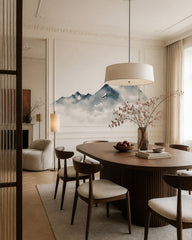 Watercolor mountain wallpaper in a refined dining area.
