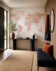 Pink watercolor world map wallpaper in a designer entrance hall.
