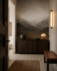 Misty mountain range wallpaper in a refined foyer.