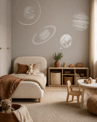 Minimalist planets wallpaper in a toddler bedroom with a child-sized bed.
