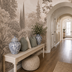 Beige botanical forest mural with detailed foliage and tall trees in a bright hallway with blue and white ceramic decor.