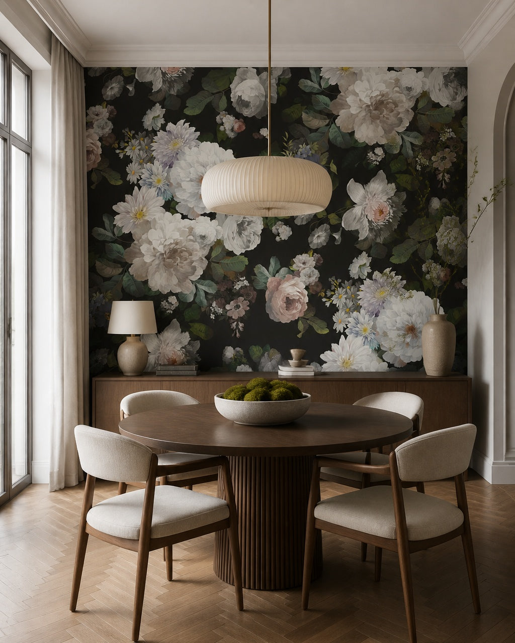 White peonies on black wallpaper in a dining room with a round table.