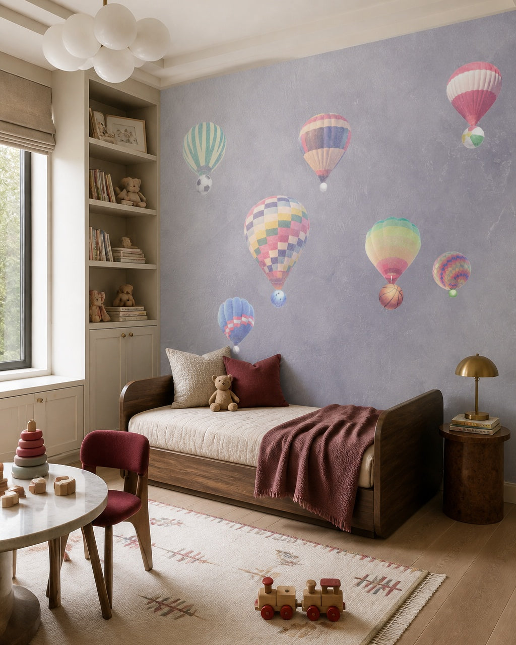 Watercolor hot air balloons wallpaper in a toddler bedroom with a child-sized bed.