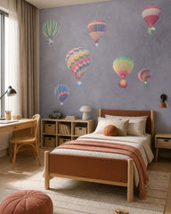 Watercolor hot air balloons wallpaper in a boy’s bedroom.