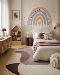 Pastel rainbow dreams nursery wallpaper in a girl’s bedroom.