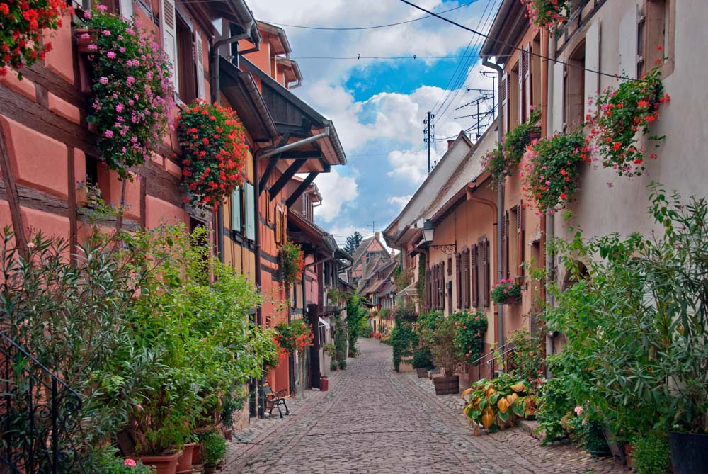 Charming Colorful European Village Street with Flowered Facades Wall Murals